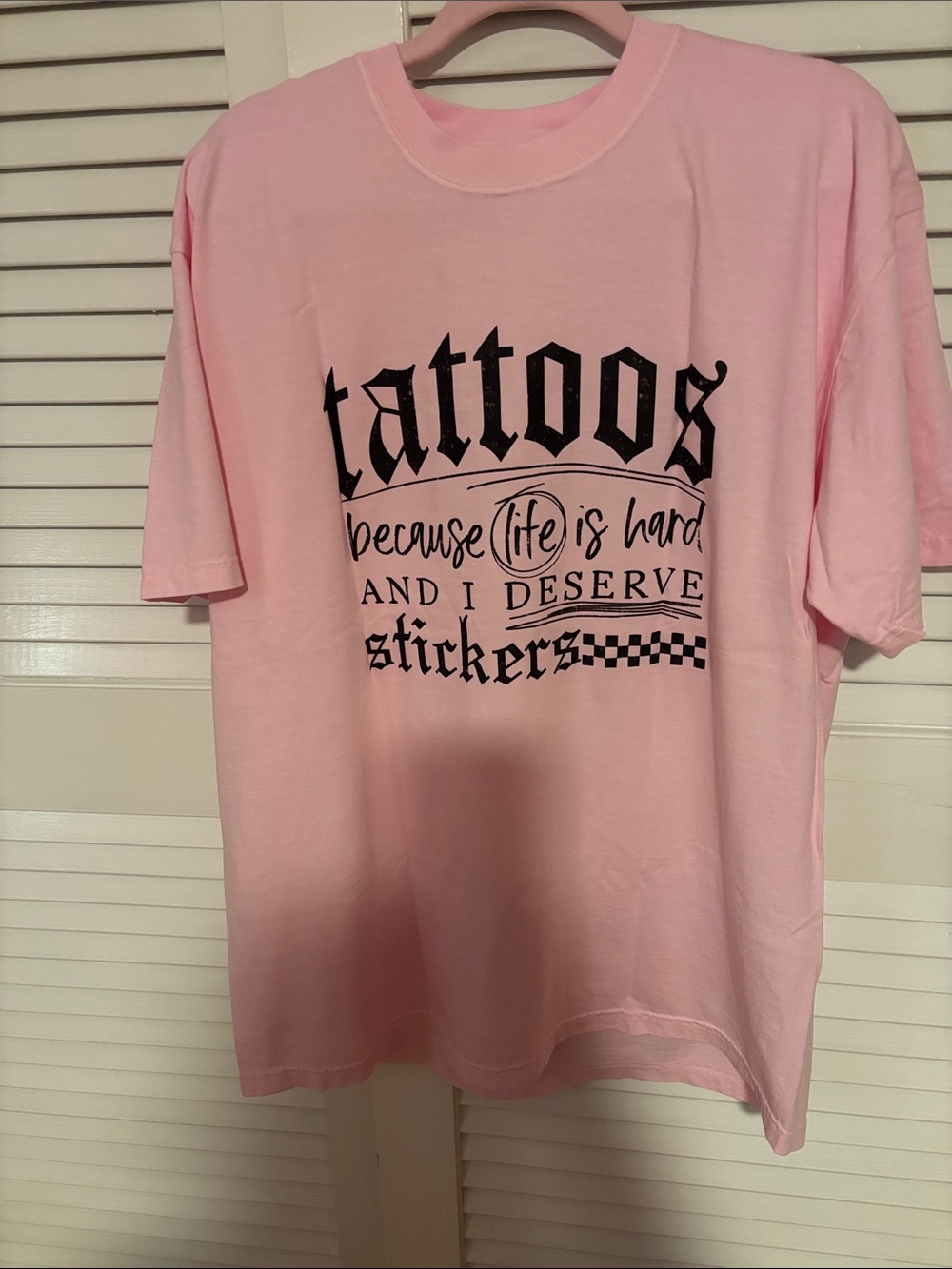 Pink Graphic Tee with 'Tattoos' Black Text